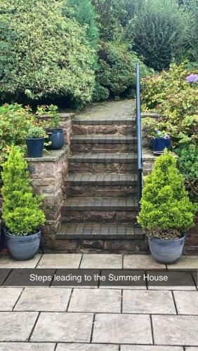 a set of steps leading to a summer house with plants at Summer House, Glassonby in Penrith