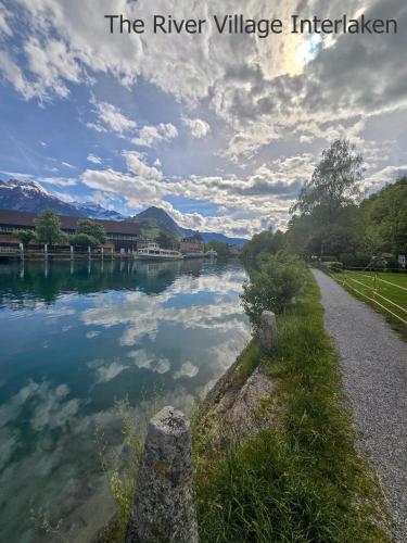 a river with reflections in the water at The River Village in Interlaken