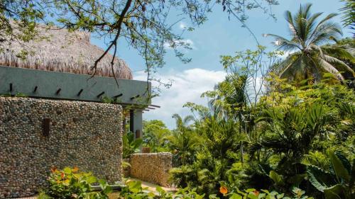 a building with a palm tree in the background at Villa Privada en Naio Palomino in Palomino