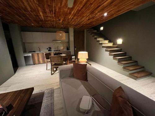 a living room with a staircase and a kitchen at Villa Privada en Naio Palomino in Palomino