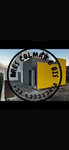 a yellow and white building with a sign on it at Près Colmar 6 bis in Wolfgantzen
