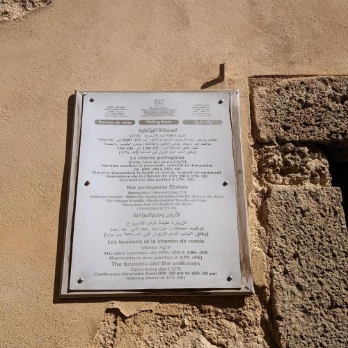 a sign attached to the side of a building at Dar Ettaki Workation Riad Cité Portugaise Mazagan in El Jadida