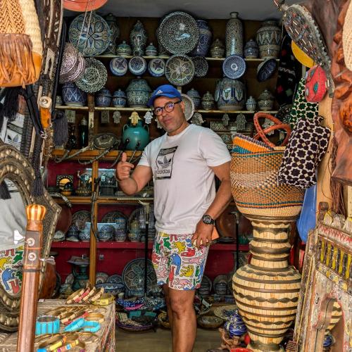 a man standing in front of a shelf of vases at Dar Ettaki Workation Riad Cité Portugaise Mazagan in El Jadida