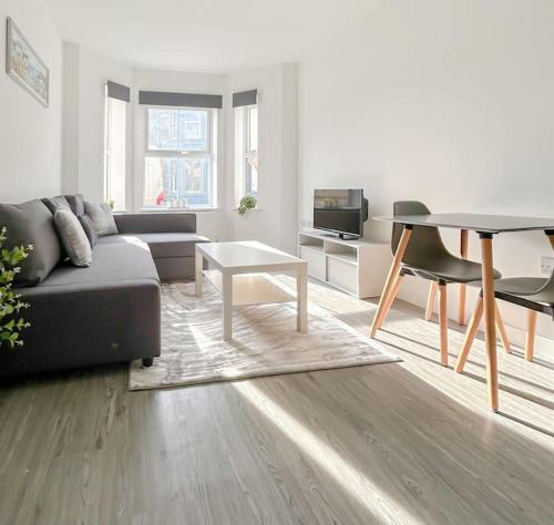 a living room with a couch and a table at Wellington Road Apartment 1 in Southtown