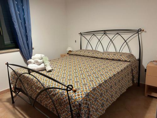 a bedroom with a bed with a teddy bear on it at Villetta sul mare in Resort Village in Campofelice di Roccella