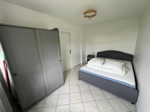- une petite chambre avec un lit et un placard dans l'établissement Studio, à Grigny