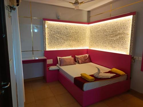 a small room with a bed with a window at Couple Friendly Bath Tub Flats in Arpora
