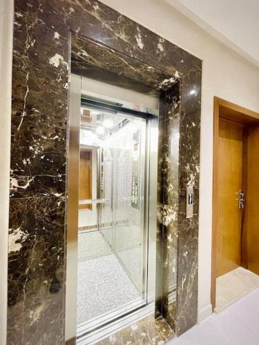 a bathroom with a glass shower with a mirror at Rayon du soleil 7 & Restaurant in Beni Touzine