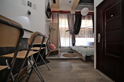 a room with a bed and a table and chairs at OFOO Zagreb in Zagreb