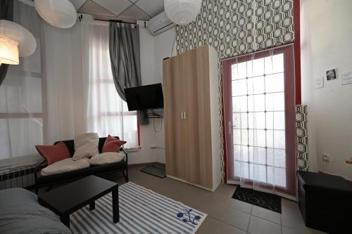 a living room with a couch and a window at OFOO Zagreb in Zagreb
