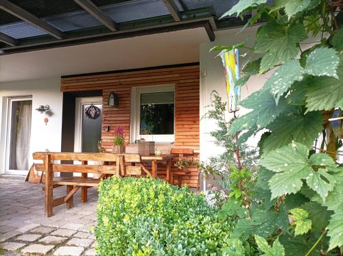 a porch with a wooden bench on a house at Das Nest Winterberg in Winterberg