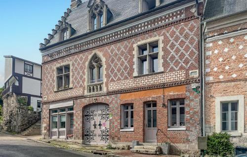 an old brick building with a door with graffiti on it at Stunning Home In Arques La Bataille Arq in Arques-la-Bataille