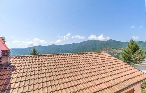 a tile roof of a house with mountains in the background at Casa La Carrugina in Carro