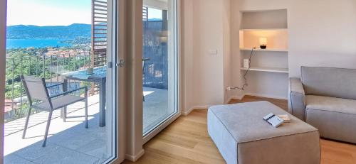 a living room with a view of a balcony at Oasi Attico in Cissano