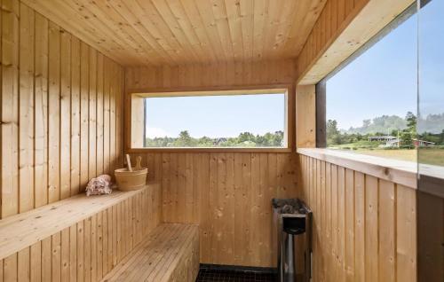 a wooden interior of a sauna with a window at Stunning Home In Ebeltoft With Sauna in Ebeltoft