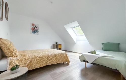a white room with a bed and a chair at Stunning Home In Guégon With Wifi in Guégon