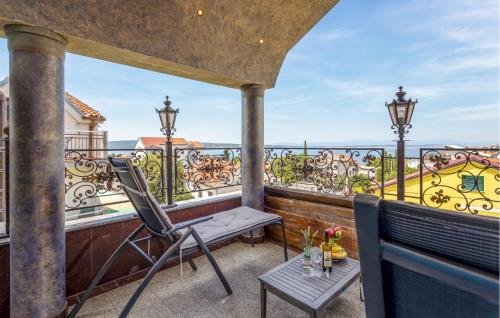 a balcony with a table and chairs on a balcony at 4 Bedroom Awesome Apartment In Selce in Selce