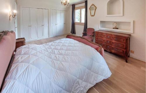 a bedroom with a large white bed and a dresser at Amazing Home In Saint-Thurien With Wifi in Saint-Thurien