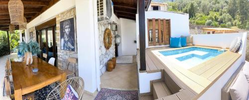 a house with a swimming pool on a balcony at Luxury Villa Athina in Nikiana