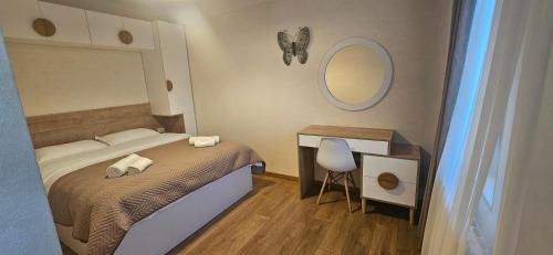 a small bedroom with a bed and a mirror at Svani in Borjomi