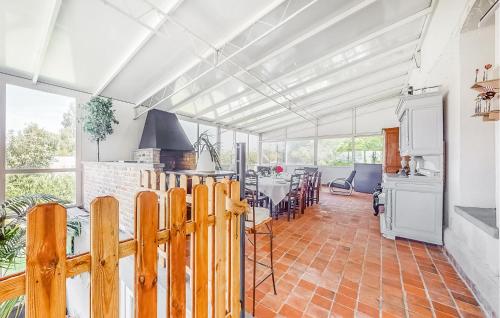 a kitchen and dining room with a wooden fence at Nice Home In Groffliers With Wifi in Groffliers