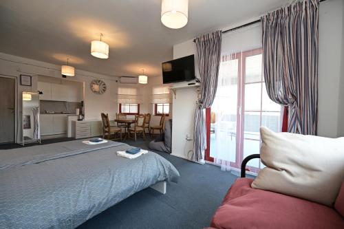 a hotel room with a bed and a kitchen at OFOO Zagreb in Zagreb