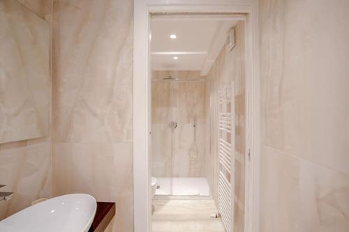 a bathroom with a shower and a toilet and a sink at Servi Deluxe Apartament in Florence