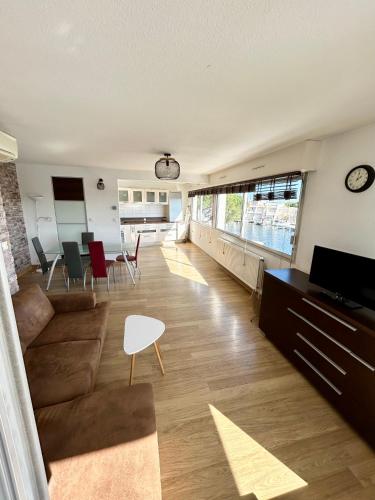 un salon avec un canapé et une table dans l'établissement Marina Régates, au Grau-du-Roi