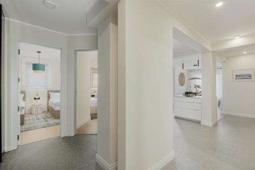 a white hallway with a bedroom and a bathroom at Dimitris Residence in Tivat