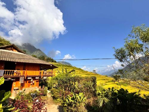 a house on a hill next to a field at Surelee Homestay in Sa Pa