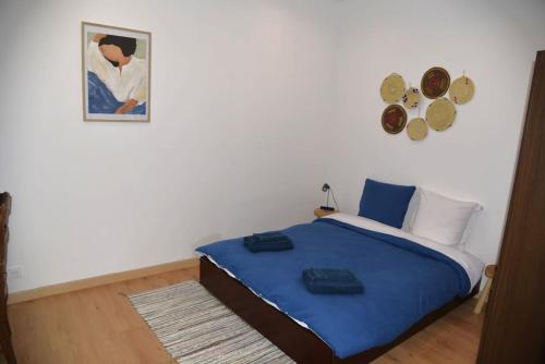 - une chambre avec un lit bleu et une photo sur le mur dans l'établissement Casa Azul, hyper centre - Cours Julien - 4 personnes, à Marseille
