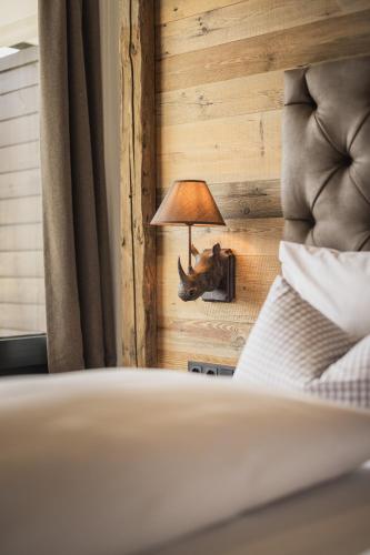 a lamp on a wall next to a bed at Wilderer Ferienwohnung in Telfs