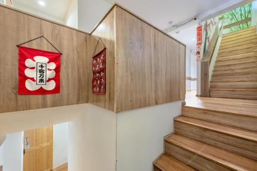 a staircase in a building with a red and white sign at โรงแรมชิบะรูม นครราชสีมา สาขามหาวิทยาลัยเทคโนโลยีสุรนารี in Nakhon Ratchasima