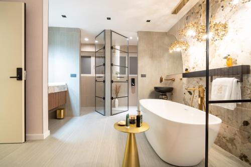 a bathroom with a large tub and a shower at Luxury Rooms - FOR GIFT in Zadar