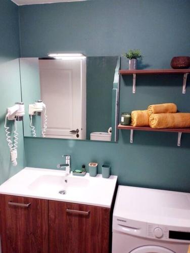 a bathroom with a sink and a toilet and a mirror at Studio Le Jacana dans une résidence de vacances avec piscine in Bellevue