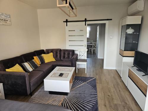 a living room with a couch and a table at Apartament z ogrodem in Lublin
