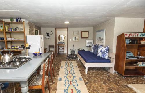 a living room with a bed and a kitchen at Hennie's Rest in Malelane