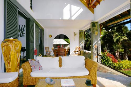 a living room with a white couch on a porch at Villa Ayapana in Le Morne