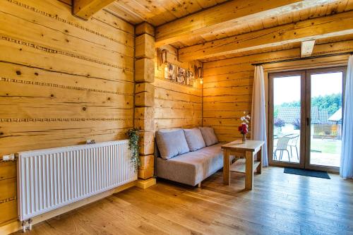 a living room with a couch in a wooden room at Agro Solina in Solina
