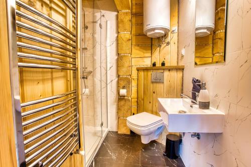 a bathroom with a white sink and a toilet at Agro Solina in Solina