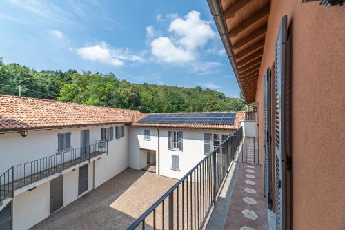 a balcony with solar panels on the roofs of buildings at Alex's Luxury Lake View Apt Pool and Tennis in Como