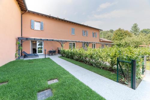 a house with a lawn in front of it at Alex's Luxury Lake View Apt Pool and Tennis in Como