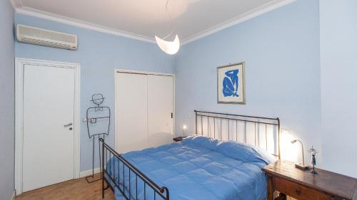 1 dormitorio con 1 cama con edredón azul en Rental in Rome Risorgimento view Aparment, en Roma