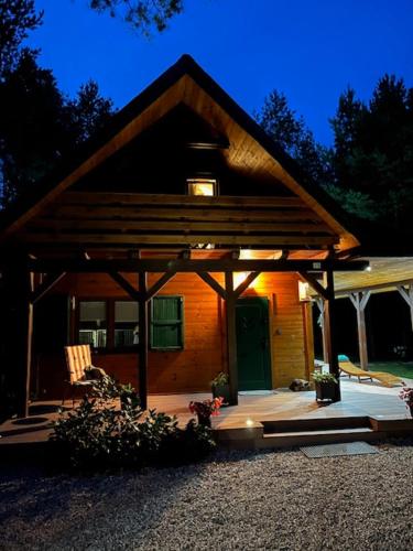 a small house with a pavilion in front of it at Domek Zielona Sowa in Siemianówka