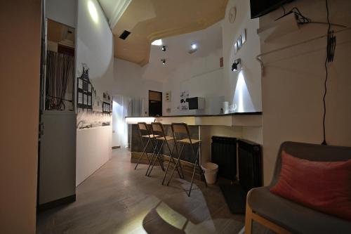 a kitchen with a bar and chairs in a room at OFOO Zagreb in Zagreb