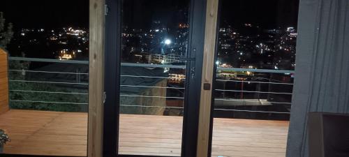 a view of a city from a balcony at night at My house in Stepantsminda