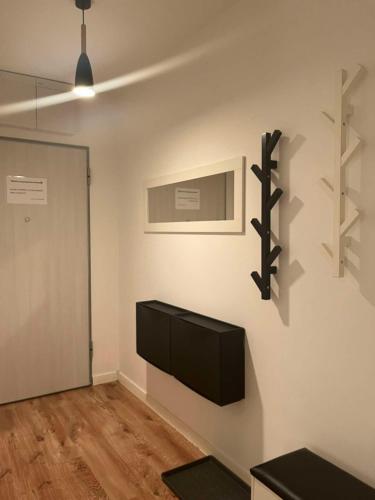 a living room with a tv on a wall at Apartament Andrea in Oleśnica