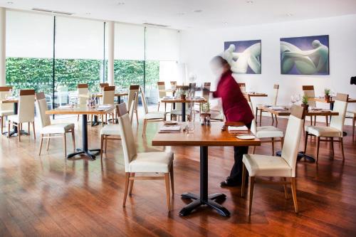 una mujer sentada en una mesa en un restaurante en Lanes Hotel en Yeovil