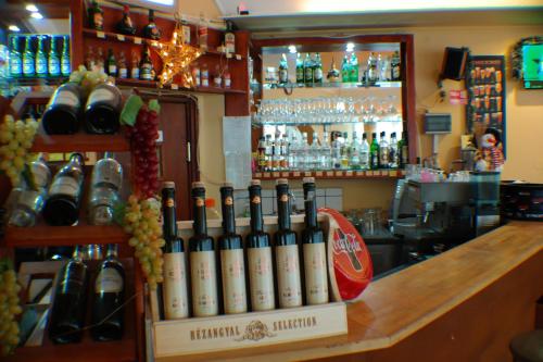 a bar with a bunch of bottles of wine at Galcsik Fogadó in Salgótarján