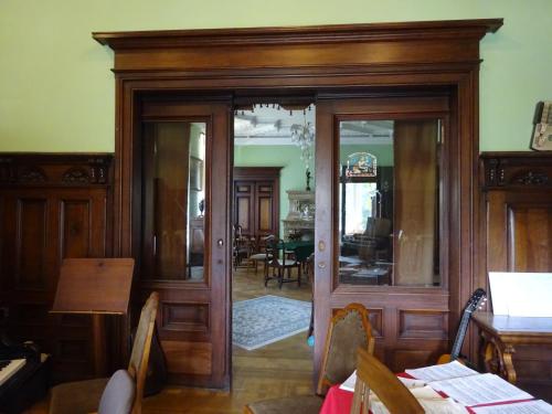 a room with a wooden door and a dining room at Villa Dietel Greiz in Greiz